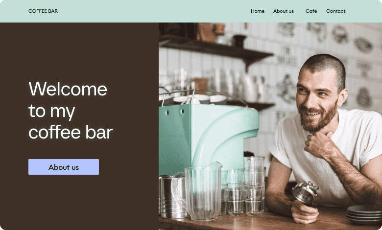 Barista smiling beside a mint-green espresso machine, with glasses on the counter and café-themed wall art in the background.
